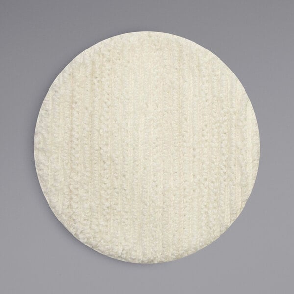 A white knitted fabric circle with a textured pattern.
