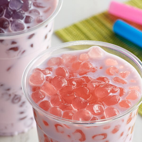 Two cups of bubble tea with Bossen Cherry Blossom Crystal Boba in pink syrup.