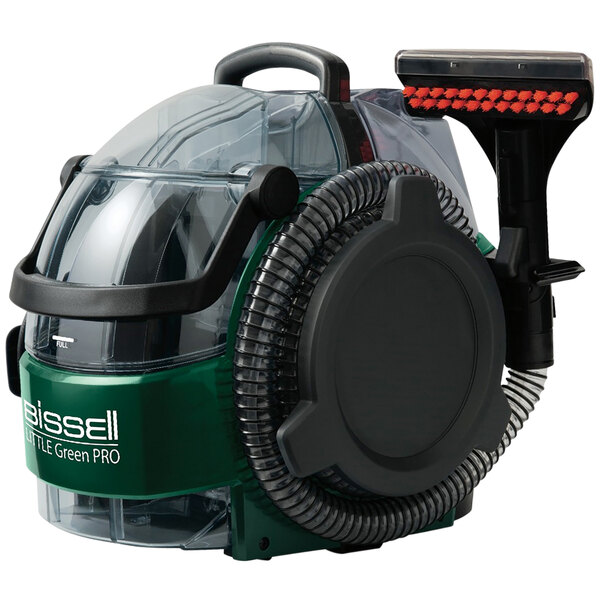 A Bissell Little Green Pro carpet spot cleaner with a green and black handle and clear container.