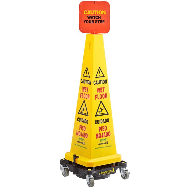 A Bissell Commercial HURRICONE yellow caution cone with a warning sign on it.