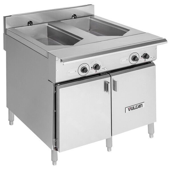 A Vulcan stainless steel double well chef station with two doors and two drawers.