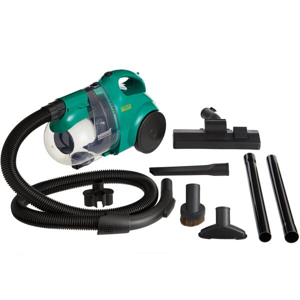 A green Bissell Commercial Little Hercules bagless canister vacuum with black hose and attachments.