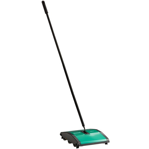 A green and black Bissell Commercial Dual Brush Floor Sweeper.