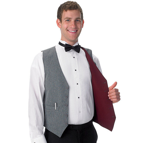 A man wearing a Henry Segal reversible server vest in burgundy and gray over a white shirt and bow tie.