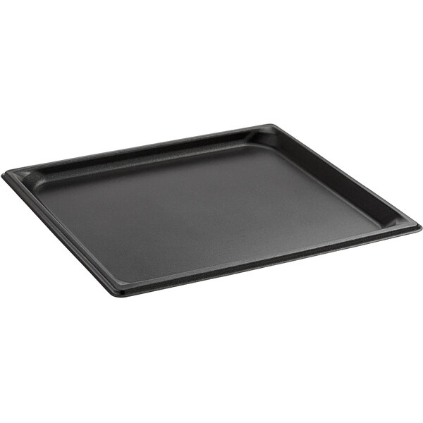 A stainless steel Vollrath steam table pan with a black border on a counter.