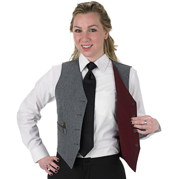A woman wearing a Henry Segal gray and burgundy reversible server vest and tie.