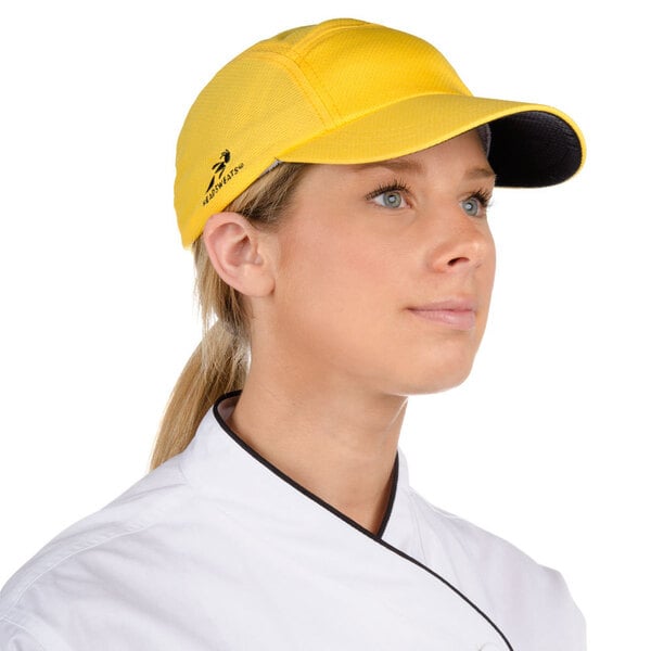 A woman wearing a yellow Headsweats 5-panel cap with a terry sweatband.