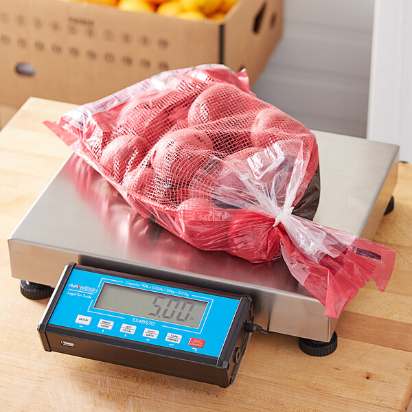 An AvaWeigh blue electronic receiving scale with a bag of potatoes on it.