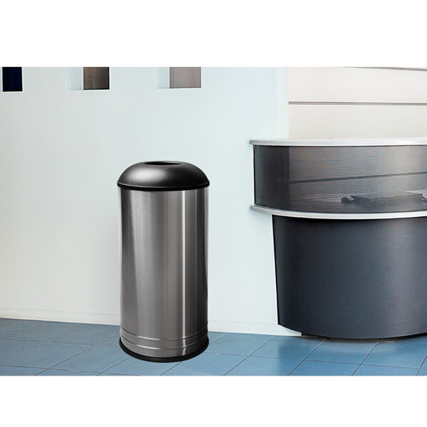 A silver Ex-Cell Kaiser International Collection stainless steel trash can with a black lid.