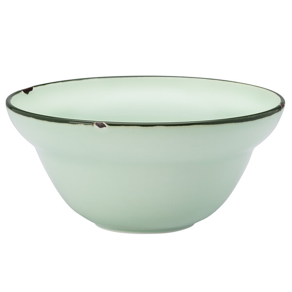 A close up of a green Luzerne Tin Tin porcelain soup bowl with a black rim.