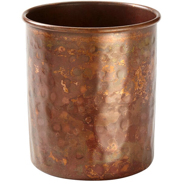 An American Metalcraft hammered antique copper cup with a textured surface.
