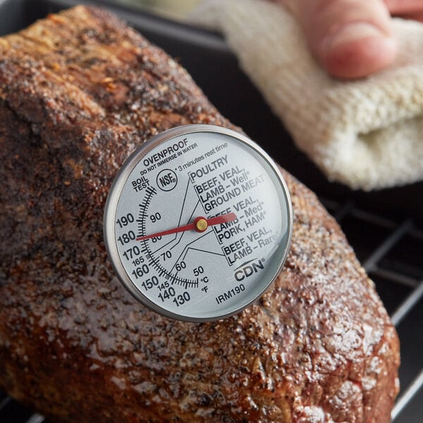 A CDN Insta-Read meat thermometer probe in a piece of meat.