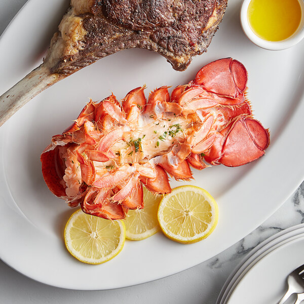 A plate with a Boston Lobster Company lobster tail and lemon slices.