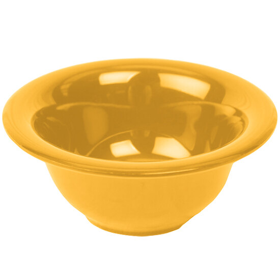 A yellow Thunder Group melamine soup bowl on a white surface.