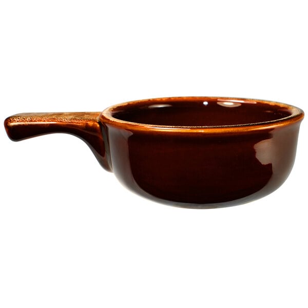 A close-up of a brown International Tableware stoneware bowl with a handle.