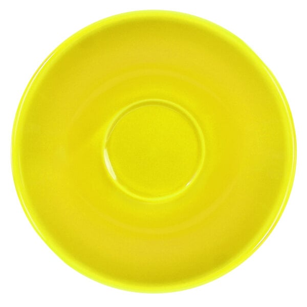 A close-up of a yellow International Tableware Cancun saucer with a circle in the middle.