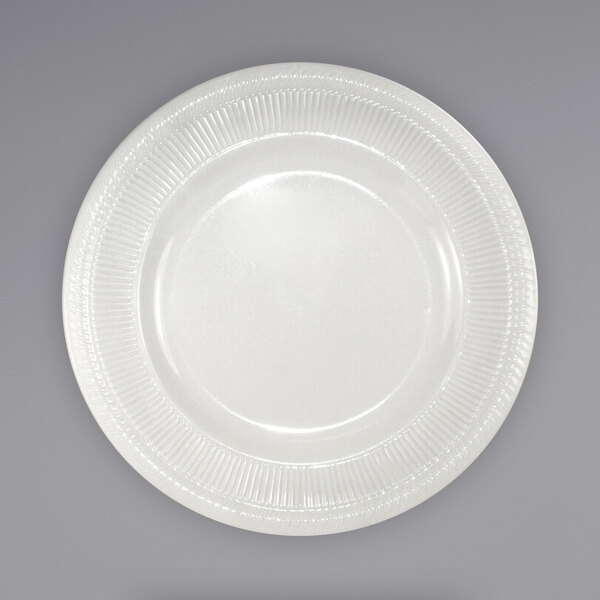 An International Tableware ivory stoneware plate with a decorative design on the rim.