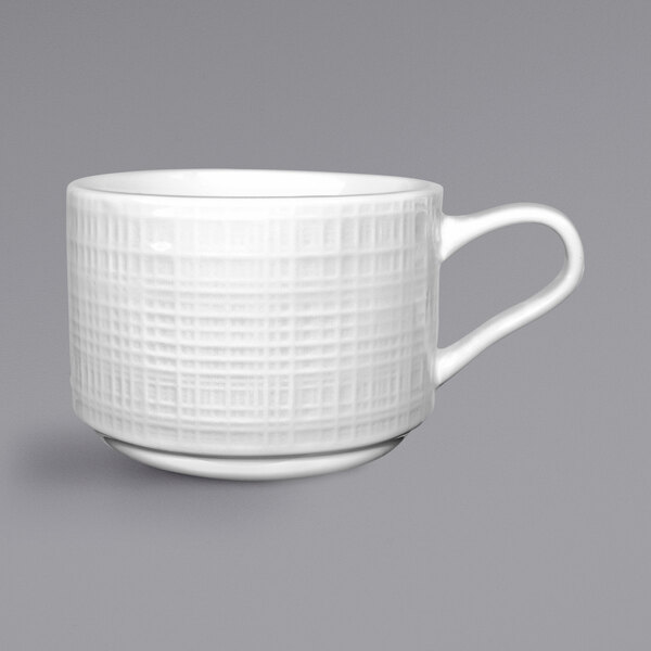 A white porcelain International Tableware Dresden cup with a handle.