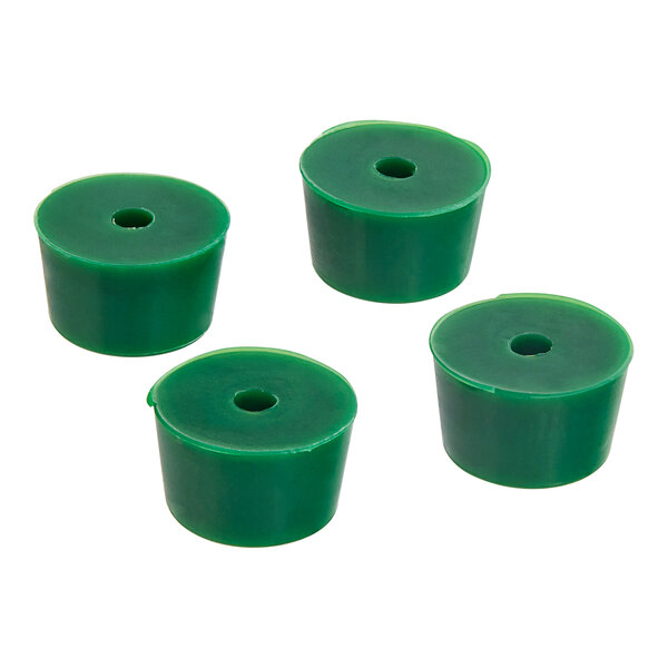 A group of green rubber feet with a hole in the center.