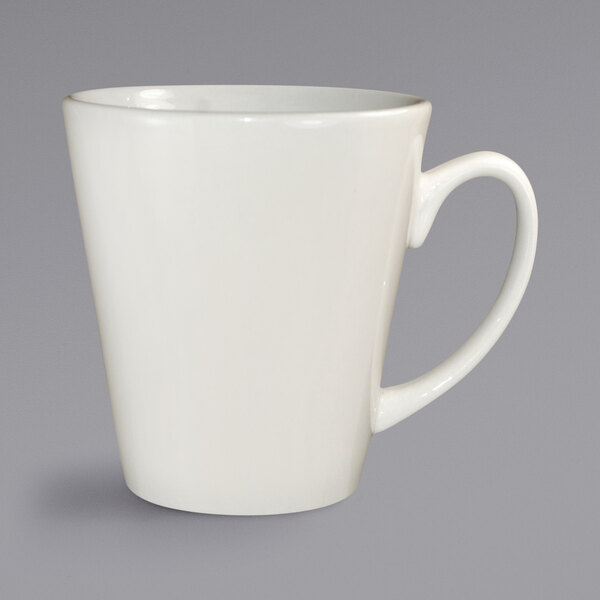 A white stoneware cup with a handle.