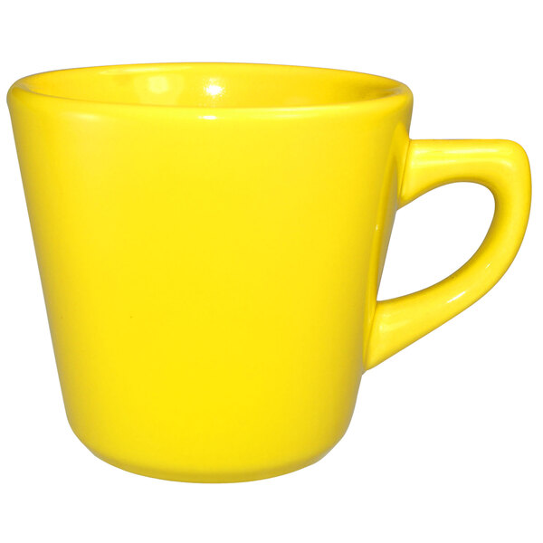 A yellow stoneware tall cup with a handle.