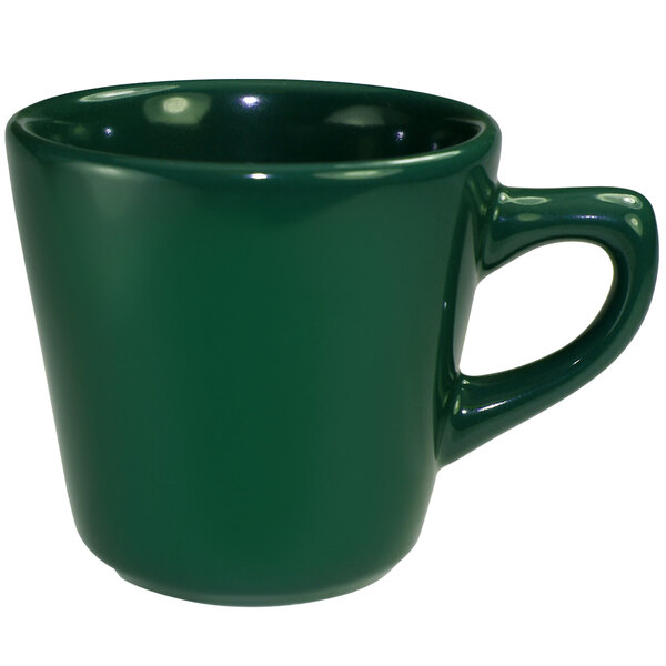 A close-up of the green handle on an International Tableware green stoneware tall cup.