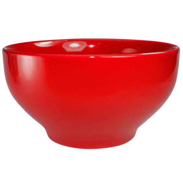 A crimson red stoneware footed bowl with a white background.