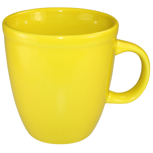 A close-up of the yellow handle of a International Tableware yellow stoneware mocha mug.