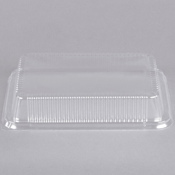 A clear plastic dome lid on a white background.