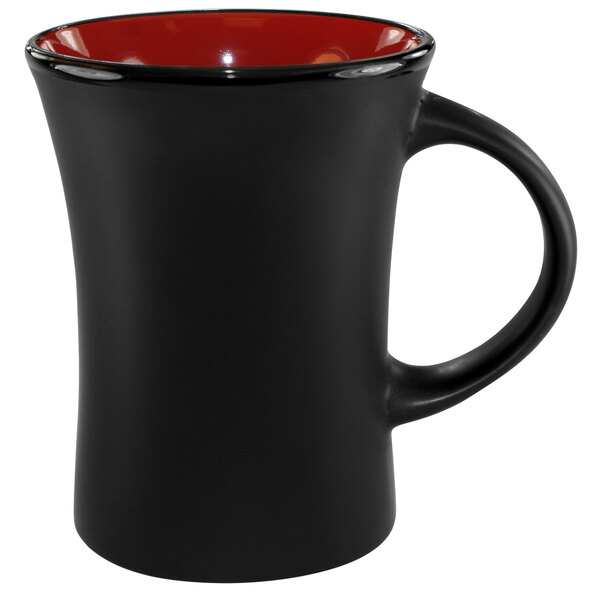 A black stoneware coffee mug with a red rim.
