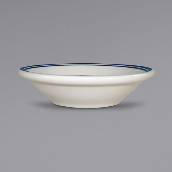 A white stoneware bowl with blue stripes on the rim.