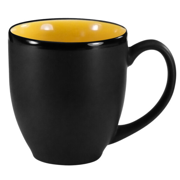 A black and yellow stoneware bistro cup with a handle.