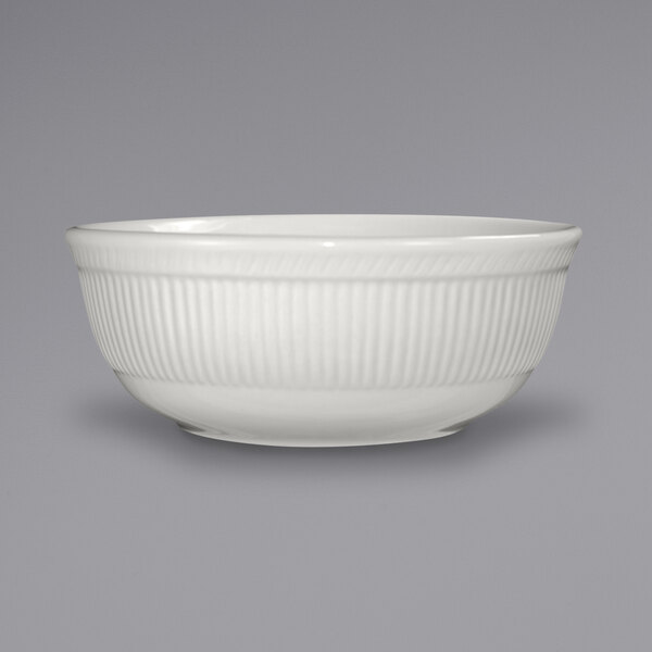 An ivory stoneware bowl with an embossed pattern.