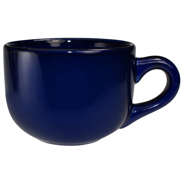 A cobalt blue stoneware latte cup with a handle.