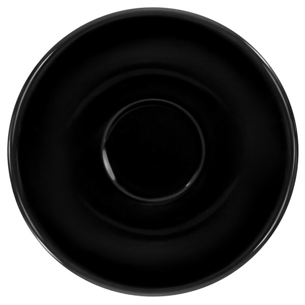 A black saucer with a white circle in the middle.
