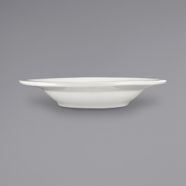 An International Tableware Athena stoneware deep rim soup bowl with a rolled edge and embossed design on a white surface.