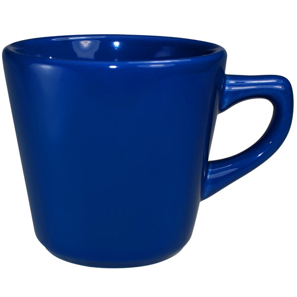 A cobalt blue stoneware tall cup with a handle.