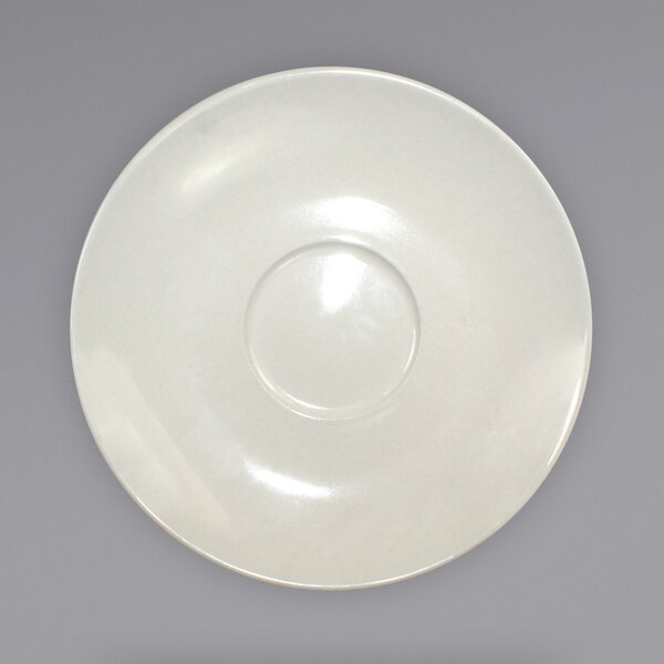 A white plate with a wide rim and circle on it.