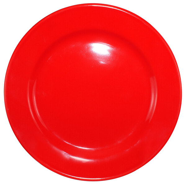 A crimson red stoneware plate with a rolled edge and wide rim.