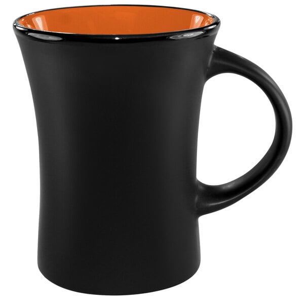 An orange mug with a black interior and a handle.