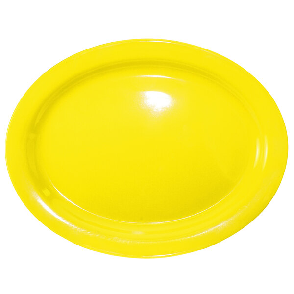 A yellow International Tableware Cancun narrow rim platter on a white surface.