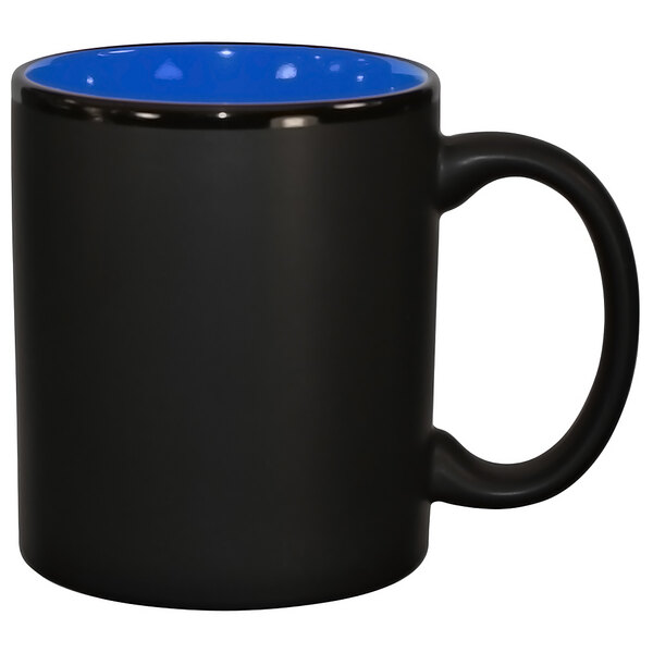 A black stoneware coffee mug with a blue rim and a C handle.
