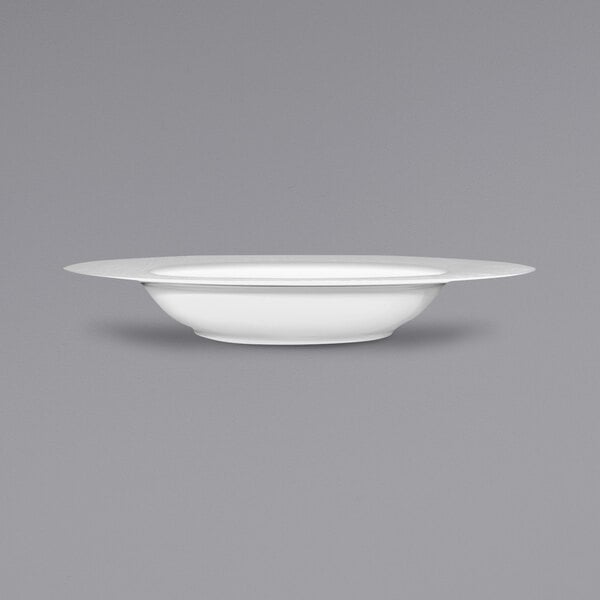 A bright white porcelain deep rim bowl by International Tableware.