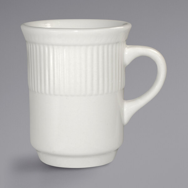 An ivory stoneware mug with a handle.