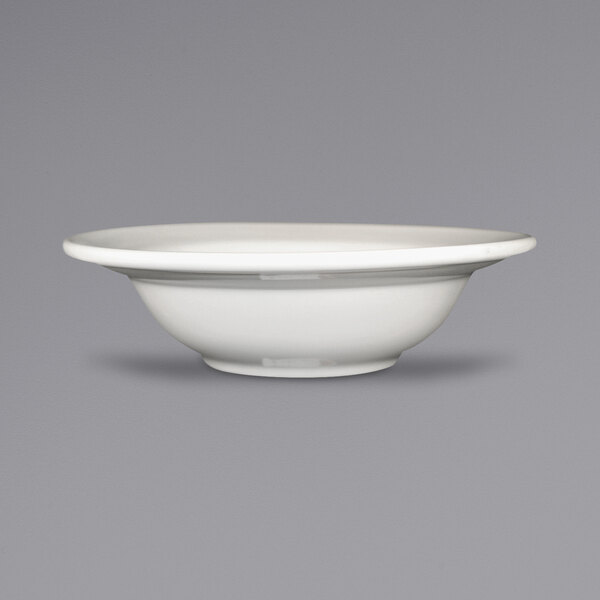 An ivory stoneware bowl with an embossed rim.
