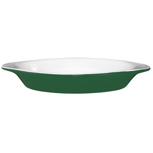 An oval green and white International Tableware rarebit dish with a rim.