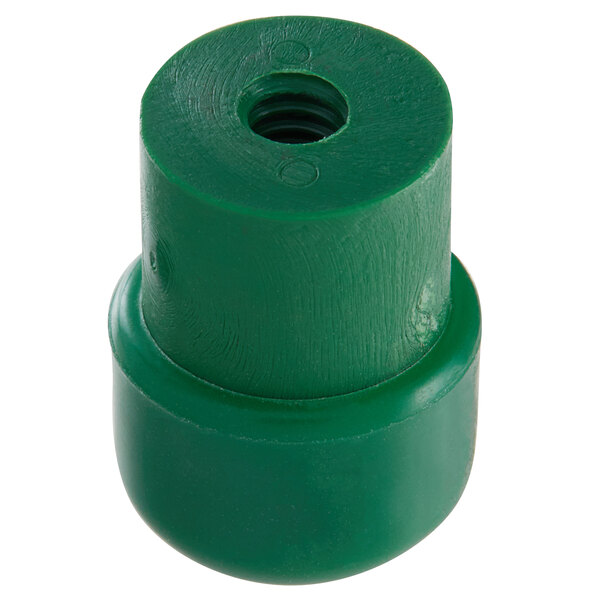 A green plastic Garde foot cap with a hole in it.