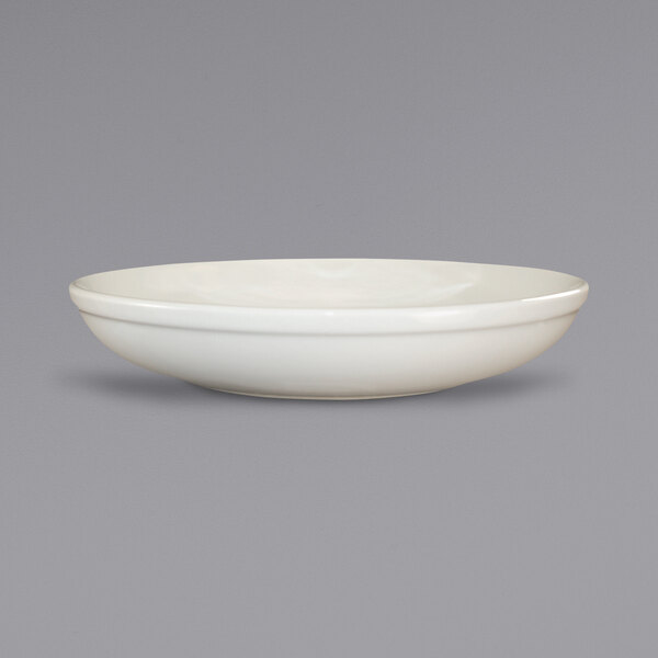 An ivory stoneware salad bowl with a rolled edge.
