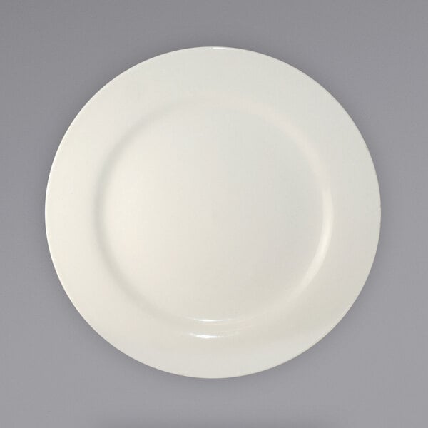 An International Tableware ivory stoneware plate with a white rim on a gray background.