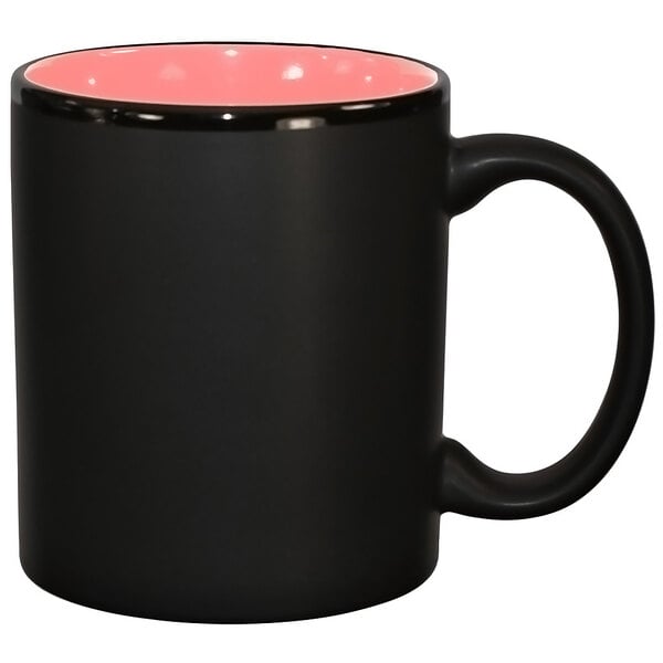 A black stoneware mug with a pink inside.